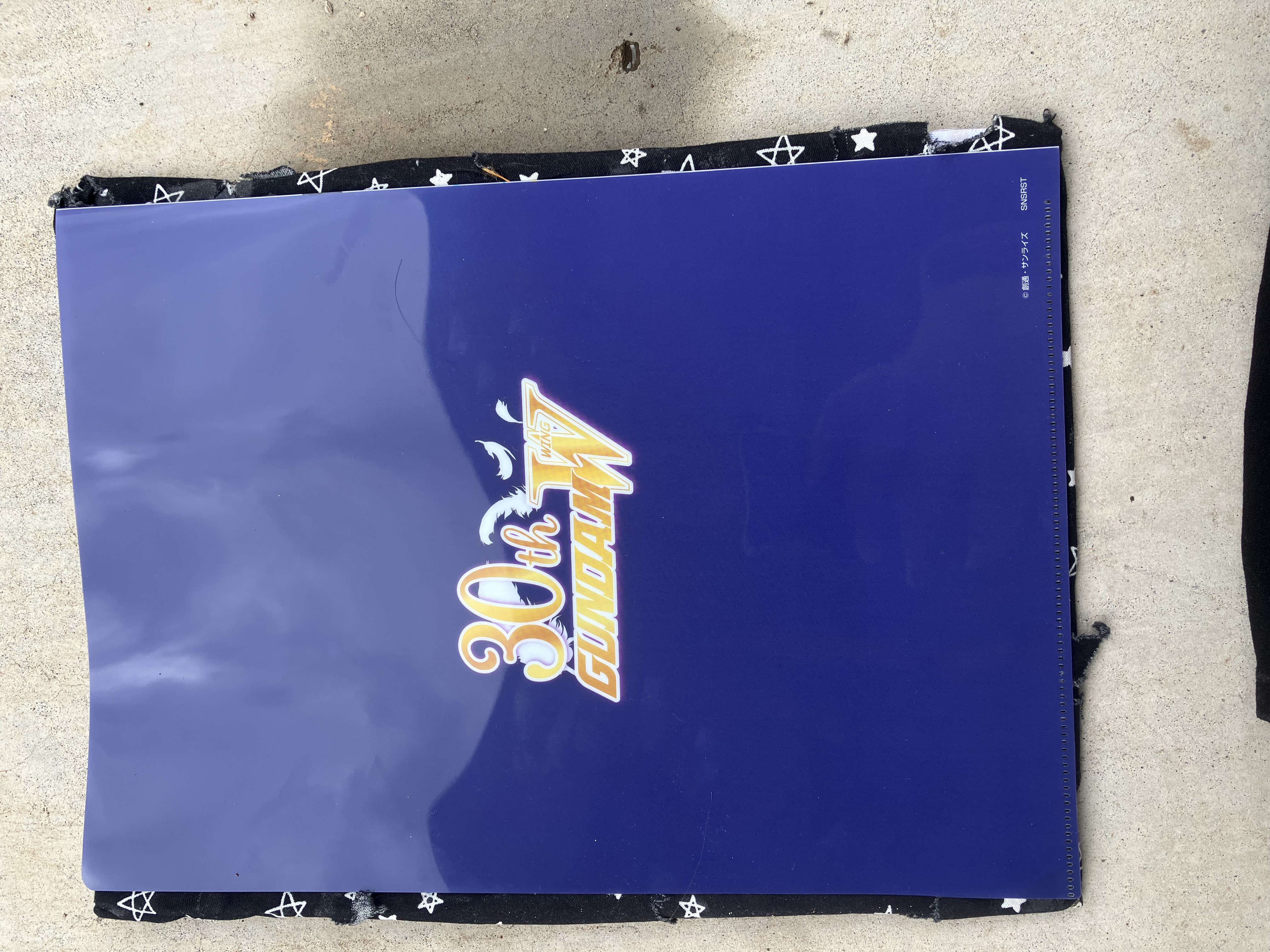 Back of clear file with Gundam wing 30th anniversary logo.